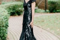 42 a refined black mermaid dress with lace appliques and embellishments plus a deep V-neckline is wow