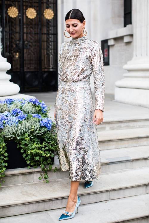 a silver sequin A-line midi dress with a high neckline, long sleeves, blue velvet embellished shoes and statement earrings