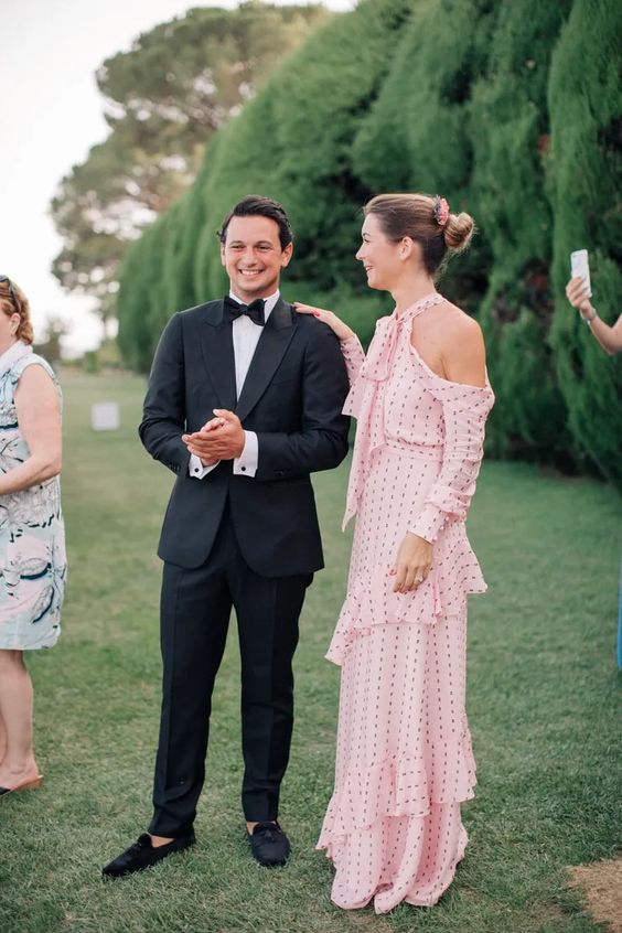 an out of the box solution for a black tie wedding - a blush maxi dress with ruffles, open shoulders and a bow, long sleeves and a polka dot print