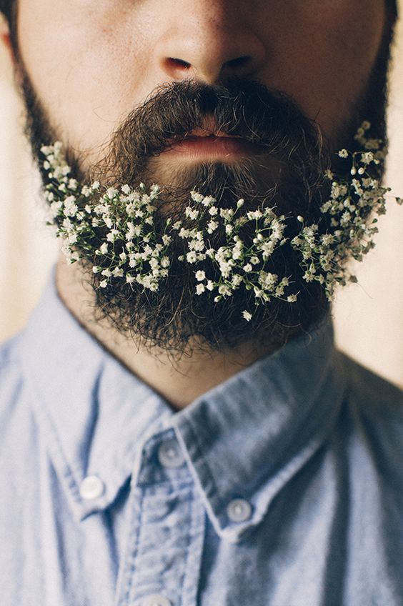 a beard decorated with white baby's breath is a lovely idea for a spring or summer groom is a chic idea