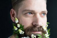 a beard with greenery and some fresh white blooms tucked in is a beautiful idea for a spring or summer wedding