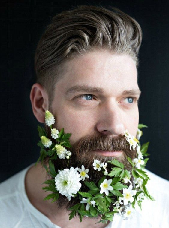 a beard with greenery and some fresh white blooms tucked in is a beautiful idea for a spring or summer wedding