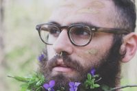 a beard with purple blooms, greenery and twigs looks very unusual, bold and fresh and will do for a wildflower or boho wedding