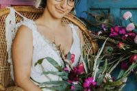 a boho bridal look with a lace A-line wedding dress with thick straps, a deep neckline and round glasses in a black frame