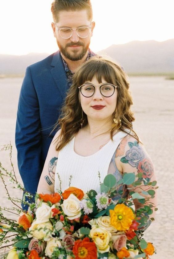 a bride that embrace her tattoos and glasses