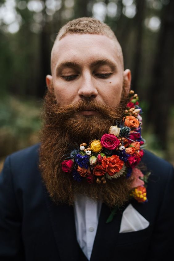 a bold and refined beard with orange, yellow, pink, blue flowers, thistles and berries is a fantastic idea for a jewel-tone wedding