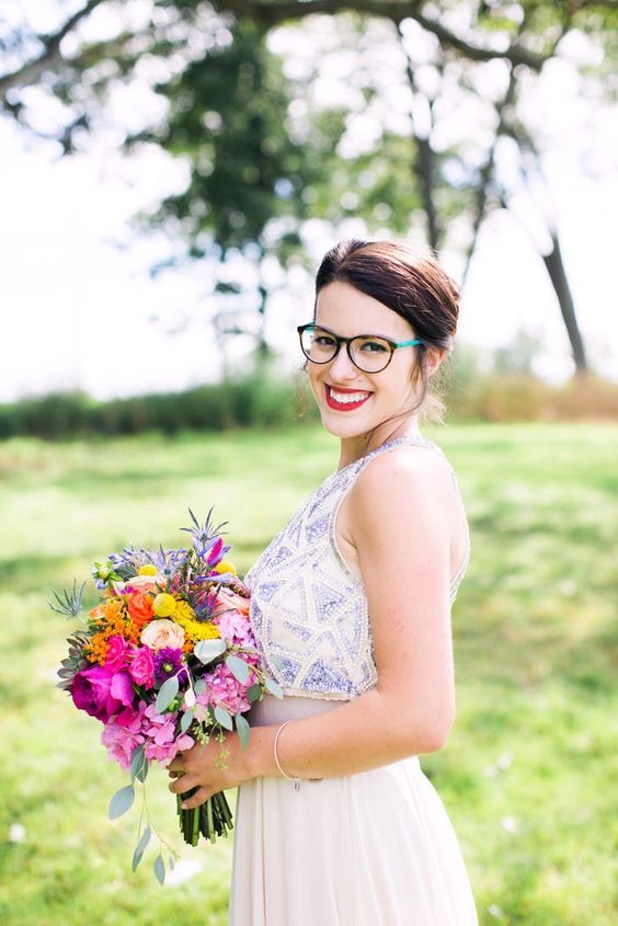 a bright look with a catchy wedding dress with a lilac embellished bodice, bold eyeglasses with a turtoise shell and turquoise frame