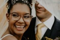 a chic bride wearing eyeglasses with a clear frame that doesn’t distract attention from either her face or her accessories