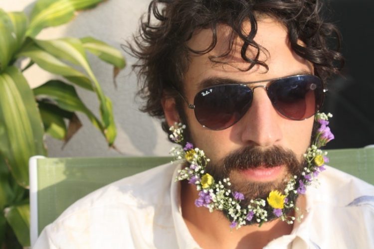 a flower beard with white, lilac and yellow blooms is a lovely touch of color to your neutral groom's look
