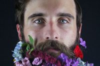 a groom rocking a trendy haircut and a beard with super brigth flowers – purple, blue, orange, red, burgundy and lilac looks unusual