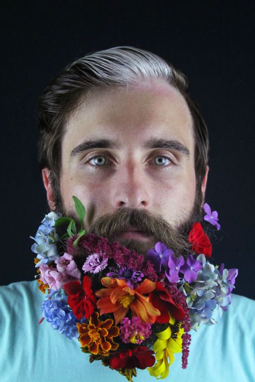 a groom rocking a trendy haircut and a beard with super brigth flowers - purple, blue, orange, red, burgundy and lilac looks unusual