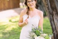 a romantic bridal look with a strapless lace wedding dress, a messy fishtail braid and stylish square glasses with a brown frame