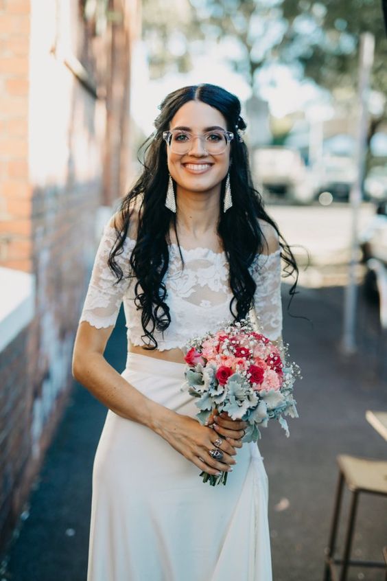 a trendy bridal look with a separate   a lace off the shoulder top and a plain skirt, statement earrings and glasses in a clear frame