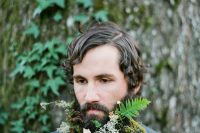 a woodland beard with fern, moss, white blooms and fall leaves is a great for a forest wedding in summer or fall
