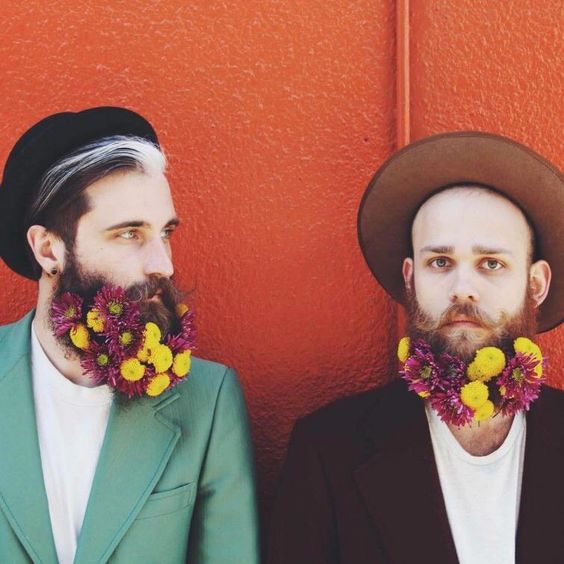 hipster grooms rocking fuchsia and yellow blooms that add plenty of color to their looks and make them bolder