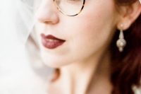 very delicate turtoise shell eyeglasses dont’ distract attention from the look of the bride and her dark lip
