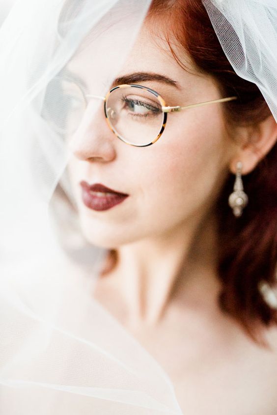 very delicate turtoise shell eyeglasses dont' distract attention from the look of the bride and her dark lip