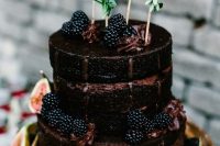 02 a chocolate naked wedding cake with blackberries, figs and greenery is a great choice for a fall wedding with a boho feel