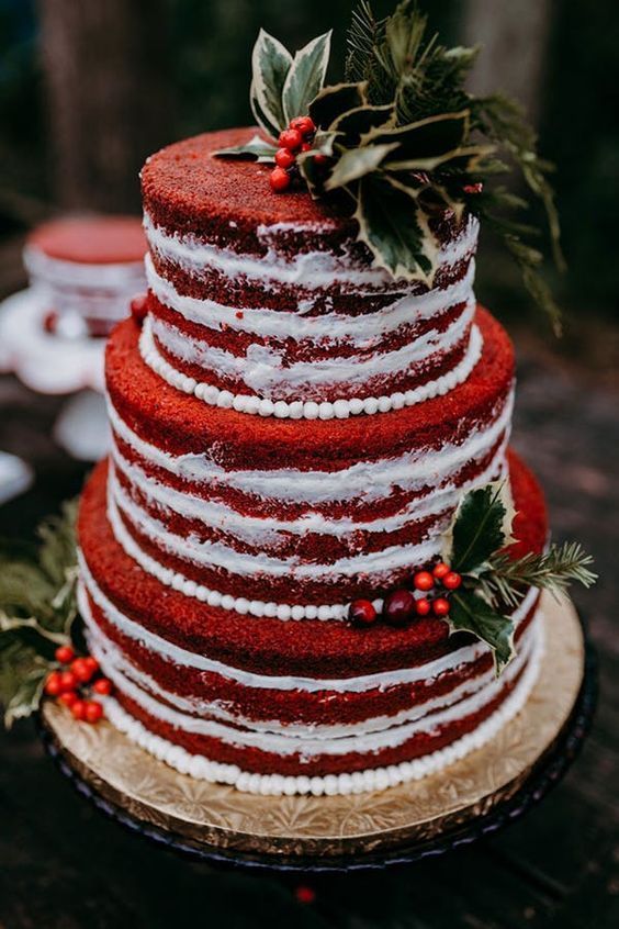 a beautiful red velvet wedding cake with white sugar beads, berries, greenery and leaves is amazing for a relaxed and rustic Christmas wedding