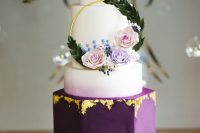 03 a bold and catchy wedding cake with ombre lilac, white and deep purple tiers, with gold leaf and pastel blooms and greenery
