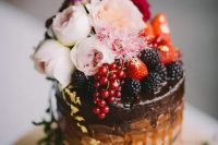 04 a chocolate wedding cake with drip, fresh berries and blush blooms on top plus gold leaf is a refined and delicious idea
