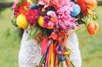 04 a colorful wedding bouquet of orange, red, purple blooms and colorful pompoms of various sizes plus bright ribbons is amazing