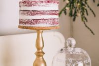 05 a chic red velvet semi-naked wedding cake topped with burgundy blooms and a gold calligraphy topper is a cool idea to rock in the fall