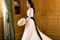 07 a classic and refined white lace wedding dress with illusion sleeves and a train, a long black ribbon sash and a cutout back with buttons