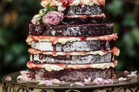 07 a mouth-watering red velvet naked wedding cake with strawberry drip, pink and white blooms and petals on the stand is a very cool idea