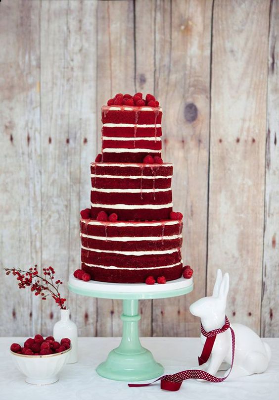 a naked red velvet wedding cake with drip and fresh berries is a perfect solution for a cozy winter or Christmas wedding
