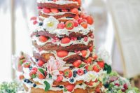 09 a gorgeous naked wedding cake with fresh bberries and white and pink blooms, with greenery is a lovely idea for a summer boho wedding