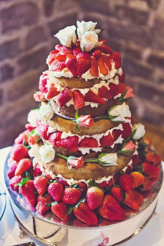 a jaw-dropping naked wedding cake with whipped cream, garden roses and lots of strawberries is a fantastic idea for a summer wedding