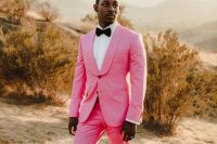 10 an edgy groom’s look with a hot pink tuxedo, a white shirt and a black bow tie, black printed loafers just wows