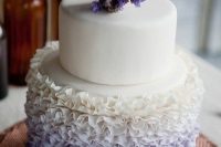 11 a fancy wedding cake with a white and ombre white to purple ruffle tier and with purple blooms on top is an amazing idea to rock