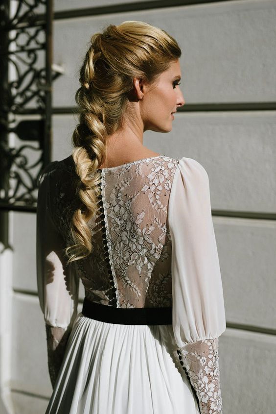 a pretty white a line wedding dress with an illusion lace back, a black sash and black buttons on the back that accent it even more