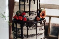 13 a naked chocolate wedding cake with chocolate drip, fresh berries and fruit is a yummy-looking idea for a fall wedding