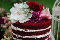 13 a stylish and cool red velvet wedding cake with pink, fuchsia, red and white blooms on top is a lovely idea for a boho woodland wedding