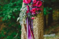 17 a bold jewel-tone wedding bouquet of hot pink blooms, thistles and greenery and long purple and gold ribbons for a bright wedding