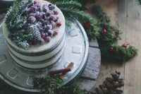 19 a naked wedding cake topped with pinecones, fir branches and sugared berries is a stylish idea for a Christmas wedding