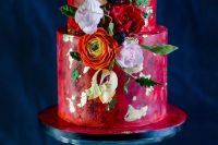 20 a bright red watercolor wedding cake with gold leaf, orange, pink and red blooms, leaves and berries is a gorgeous idea for a bold and colorful wedding