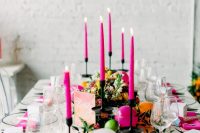20 a bright wedding tablescape with hot pink candles and napkins, citrus on the table and some yellow blooms and greenery