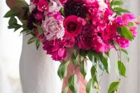 21 a dimensional and luxurious wedding bouquet of light pink, hot pink and purple blooms, greenery and pink ribbon is amazing