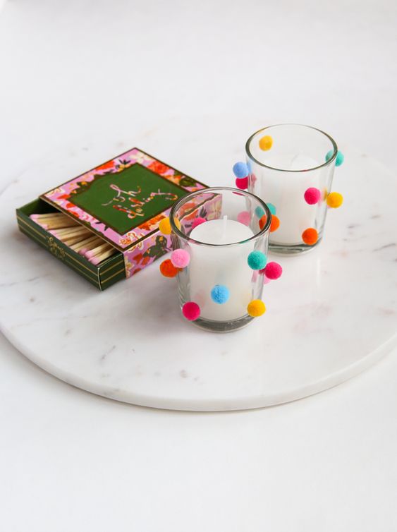 accent candleholders with colorful pompoms to give your tablescapes a fun and cool look