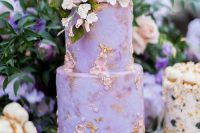 25 a sophisticated lilac wedding cake with pastel sugar decor, with fresh blooms and greenery on top is a very refined idea for your wedding