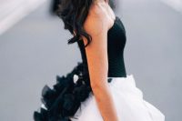 26 a wedding ballgown with a black corset bodice with black ruffles on its back and a white full skirt is a stunning contrasting idea