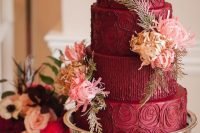 27 a refined burgundy wedding cake with chocolate patterns and fresh and tan blooms and leaves is a gorgeous idea for a fall wedding
