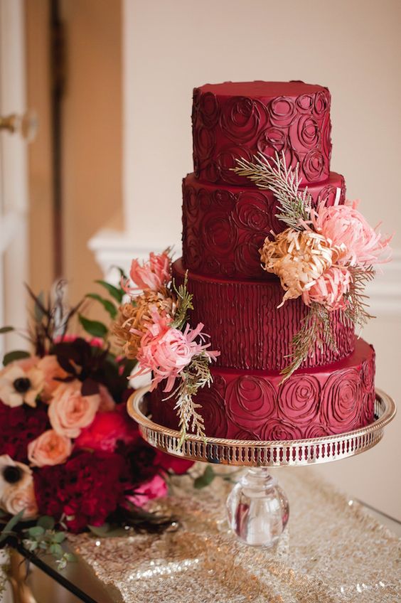 a refined burgundy wedding cake with chocolate patterns and fresh and tan blooms and leaves is a gorgeous idea for a fall wedding