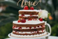 28 a naked wedding cake with strawberries and a gold LOVE topper is amazing and bold