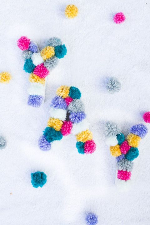 make colorful pompom monograms to decorate your wedding venue and add color and interest to it