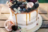29 a semi naked fall wedding cake with caramel drizzle, blackberries, figs, blooms and succulents on top